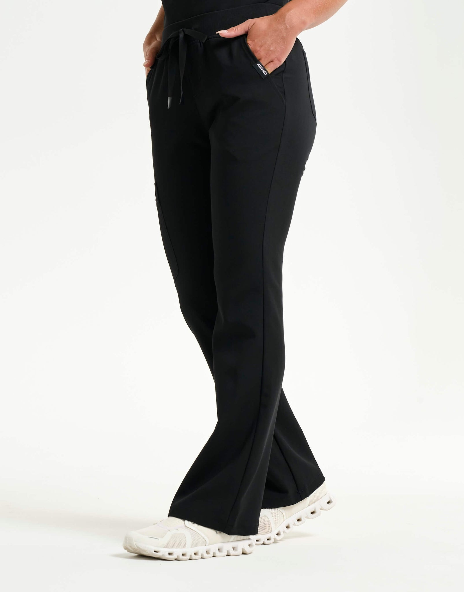 left with thigh pocket of black flare scrub pants