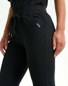 close up of hip pocket of black flare scrub pants