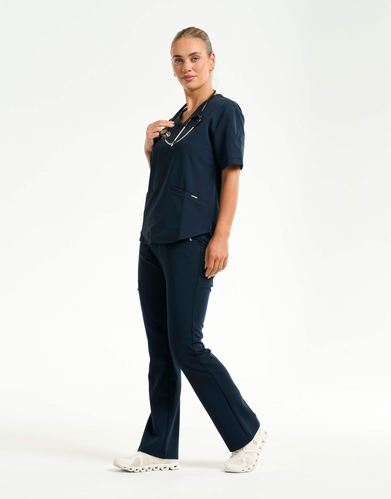full body with stethascope of midnight navy flare scrub pants