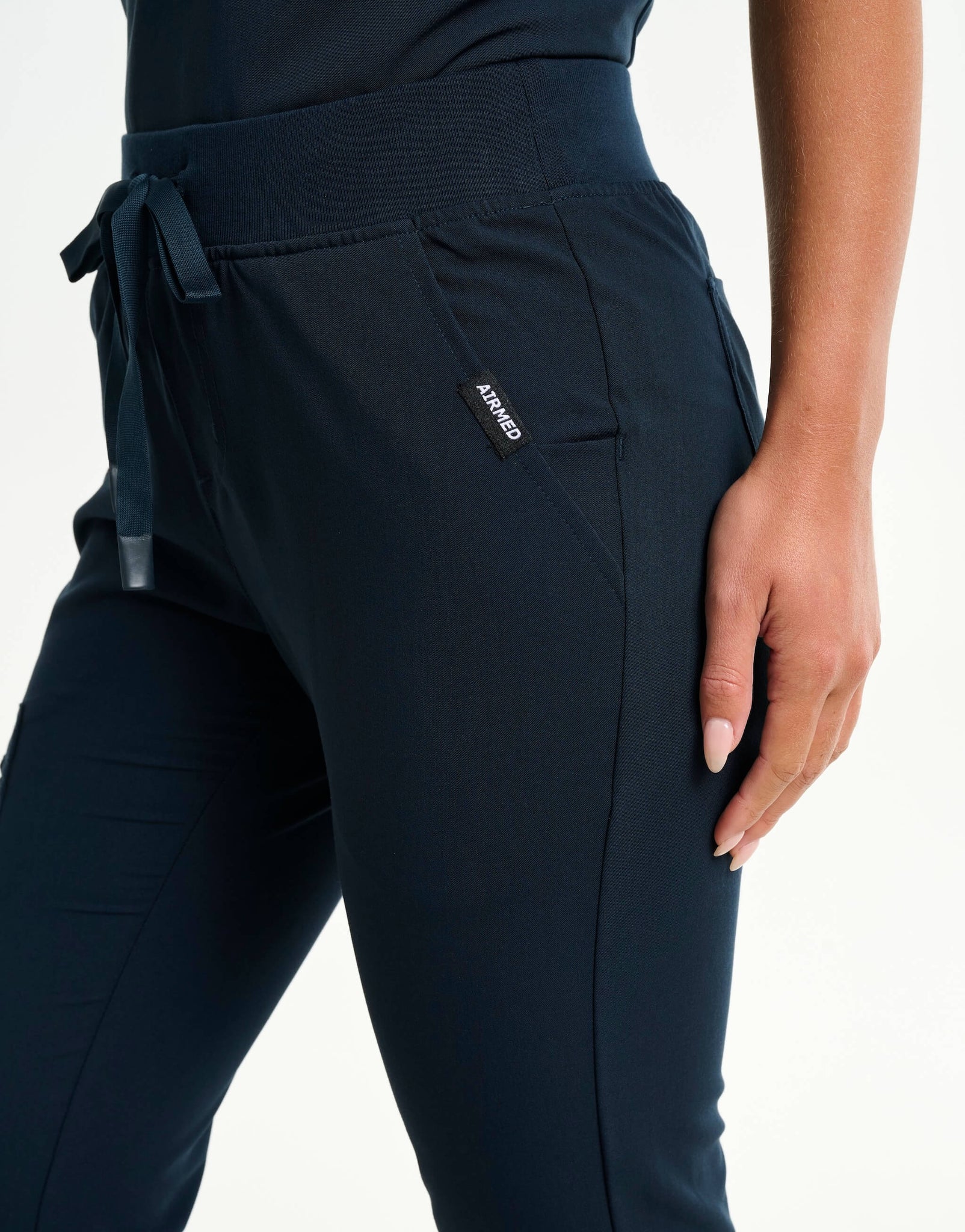 close up of hip pocket of midnight navy flare scrub pants