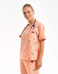 side view of peach crewneck scrub top
