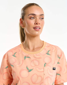 close up of neckline detail of peach crewneck scrub top