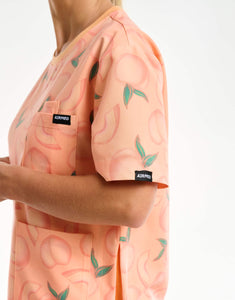 close up of sleeve detail of peach crewneck scrub top