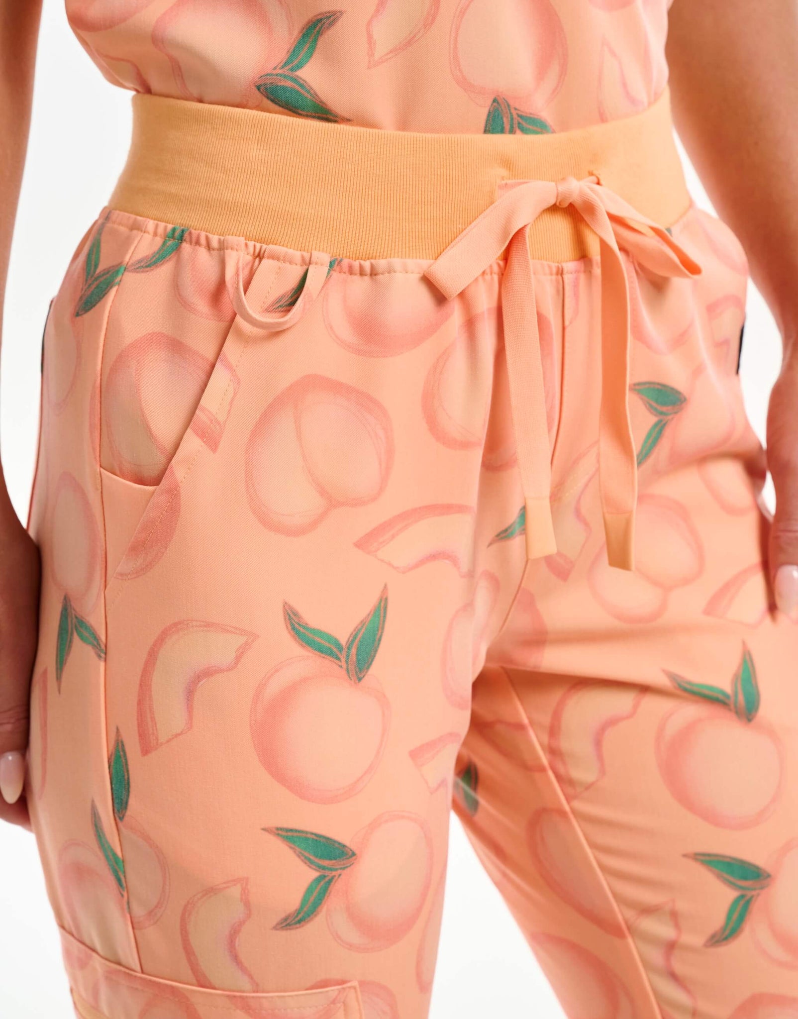 close up of ID tag of peach jogger scrub pants
