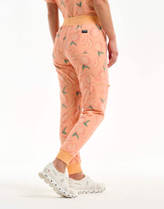 left view with thigh pocket of peach jogger scrub pants