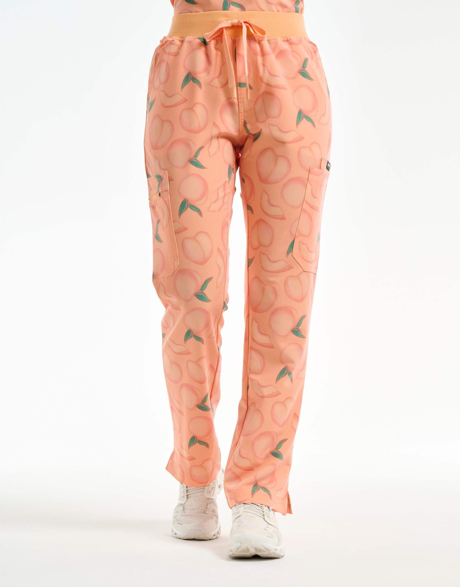 front view of peach multi-pocket scrub pants
