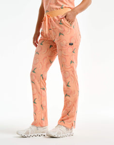 left view with thigh pocket of peach multi-pocket scrub pants
