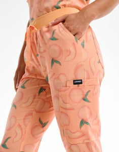 close up of hip pocket of peach multi-pocket scrub pants