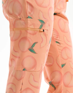 close up of thigh pocket of peach multi-pocket scrub pants