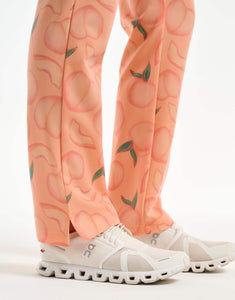 close up of ankle of peach multi-pocket scrub pants
