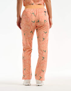back view of peach multi-pocket scrub pants