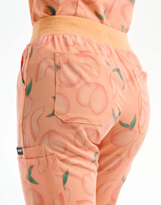 rear of peach multi-pocket scrub pants