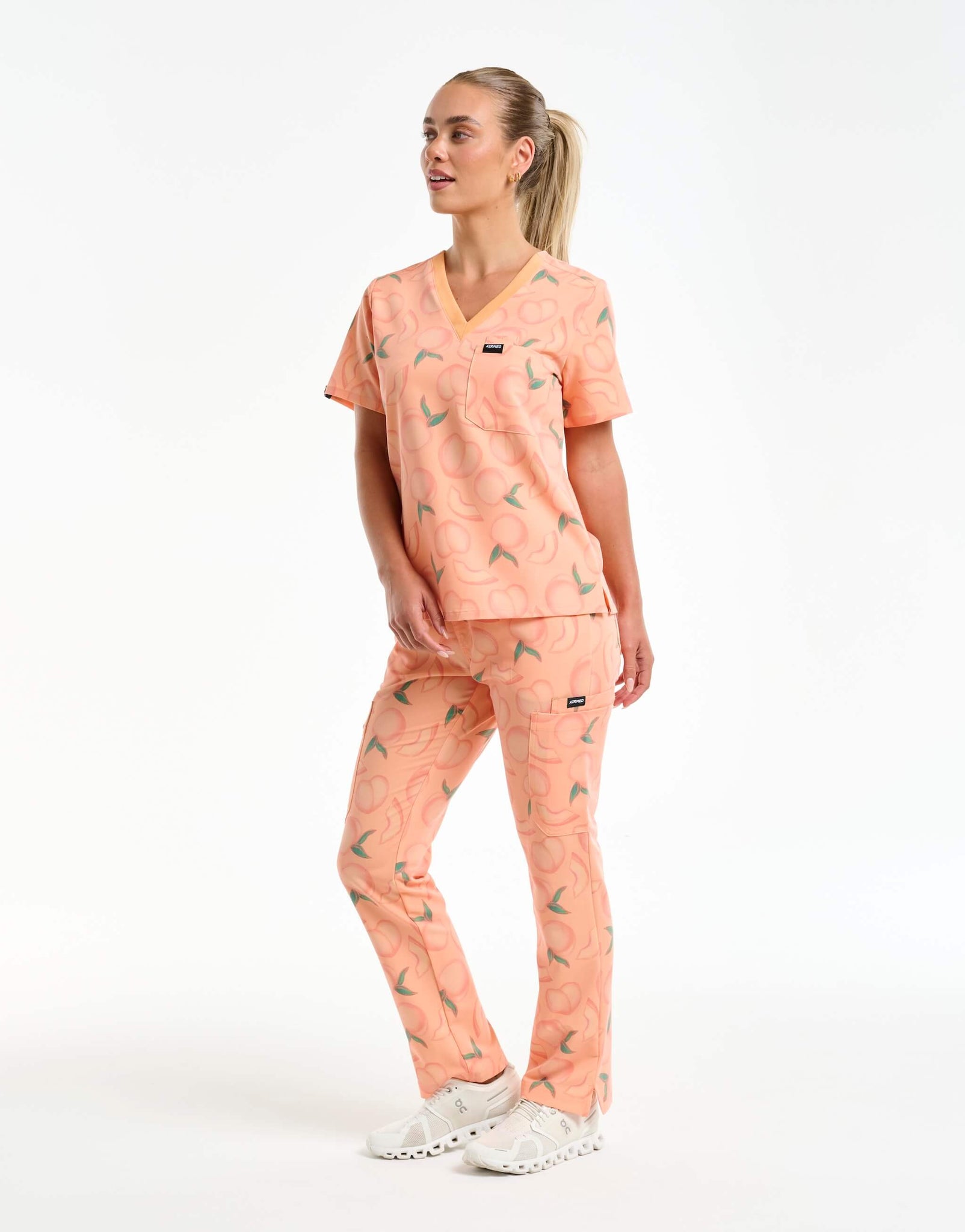 full body view of peach one pocket v neck scrub top