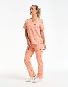 full body view of peach one pocket v neck scrub top