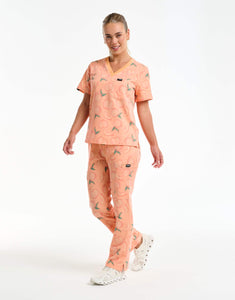 full body view of peach multi-pocket scrub pants