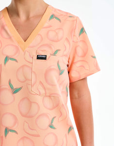 close up of pocket detail of peach one pocket v neck scrub top
