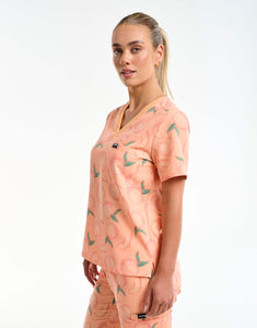side view of peach one pocket v neck scrub top