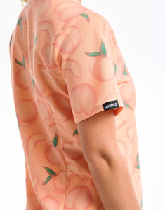 close up of sleeve detail of peach one pocket v neck scrub top