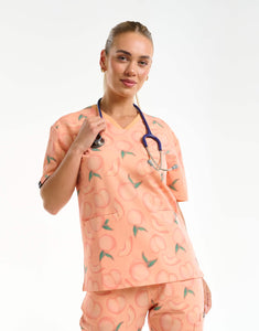 front view with stethoscope of peach v neck scrub top