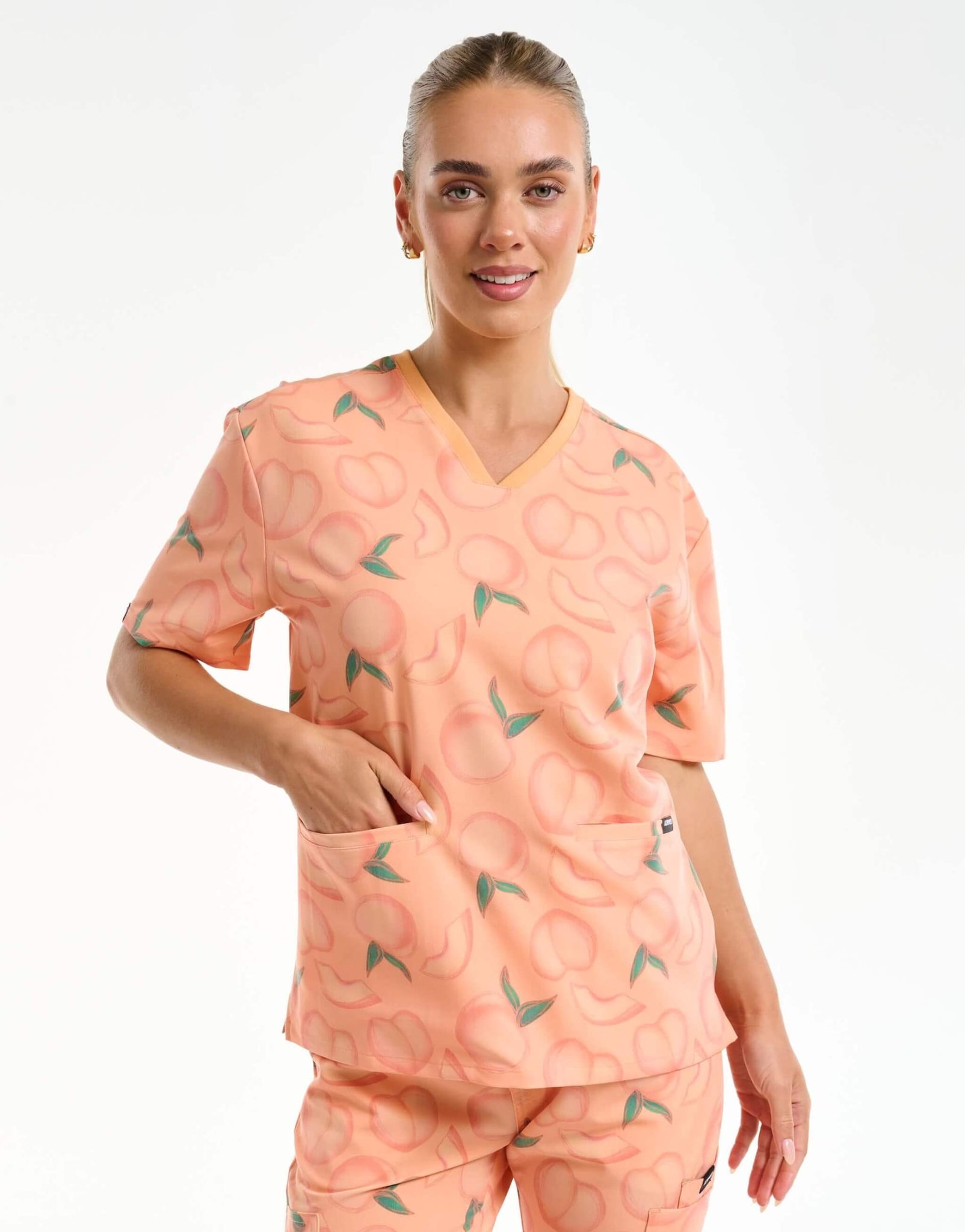 front view of peach v neck scrub top