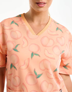 close up of neckline detail of peach v neck scrub top