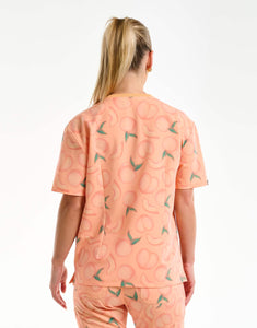 back view of peach v neck scrub top